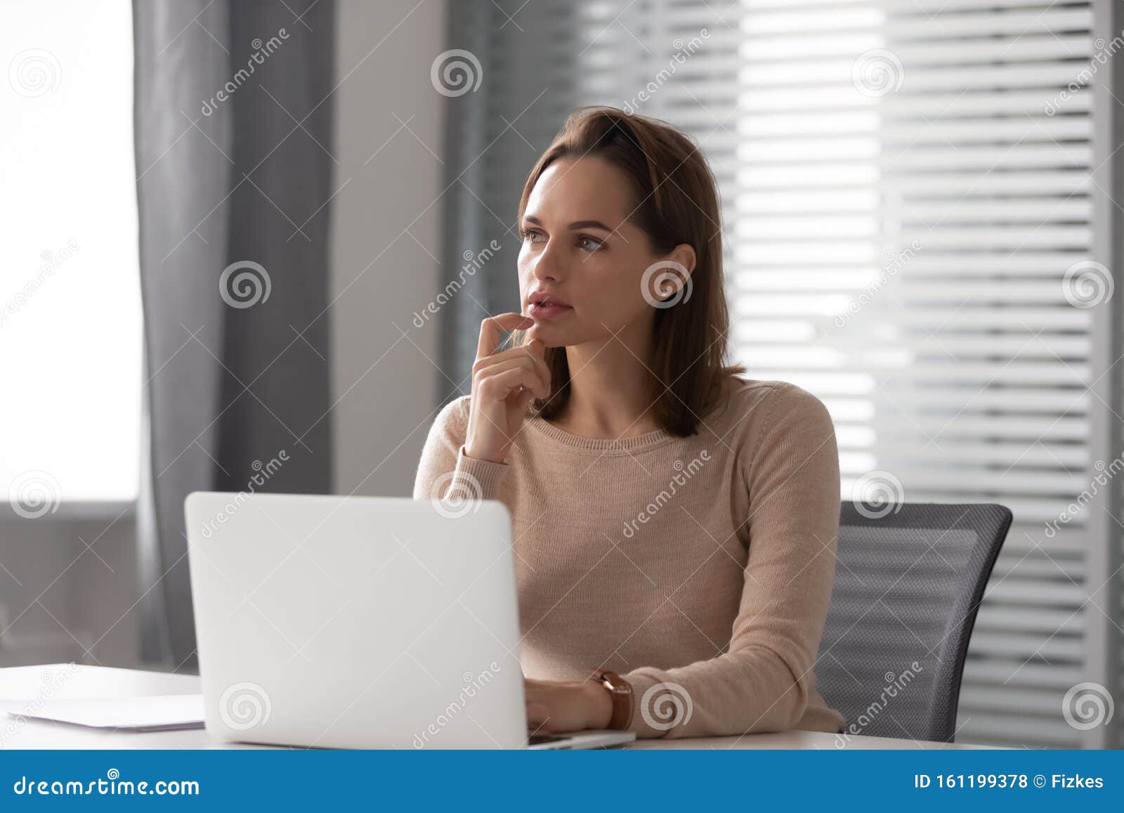 Thoughtful Businesswoman Using Laptop Pondering Online Project