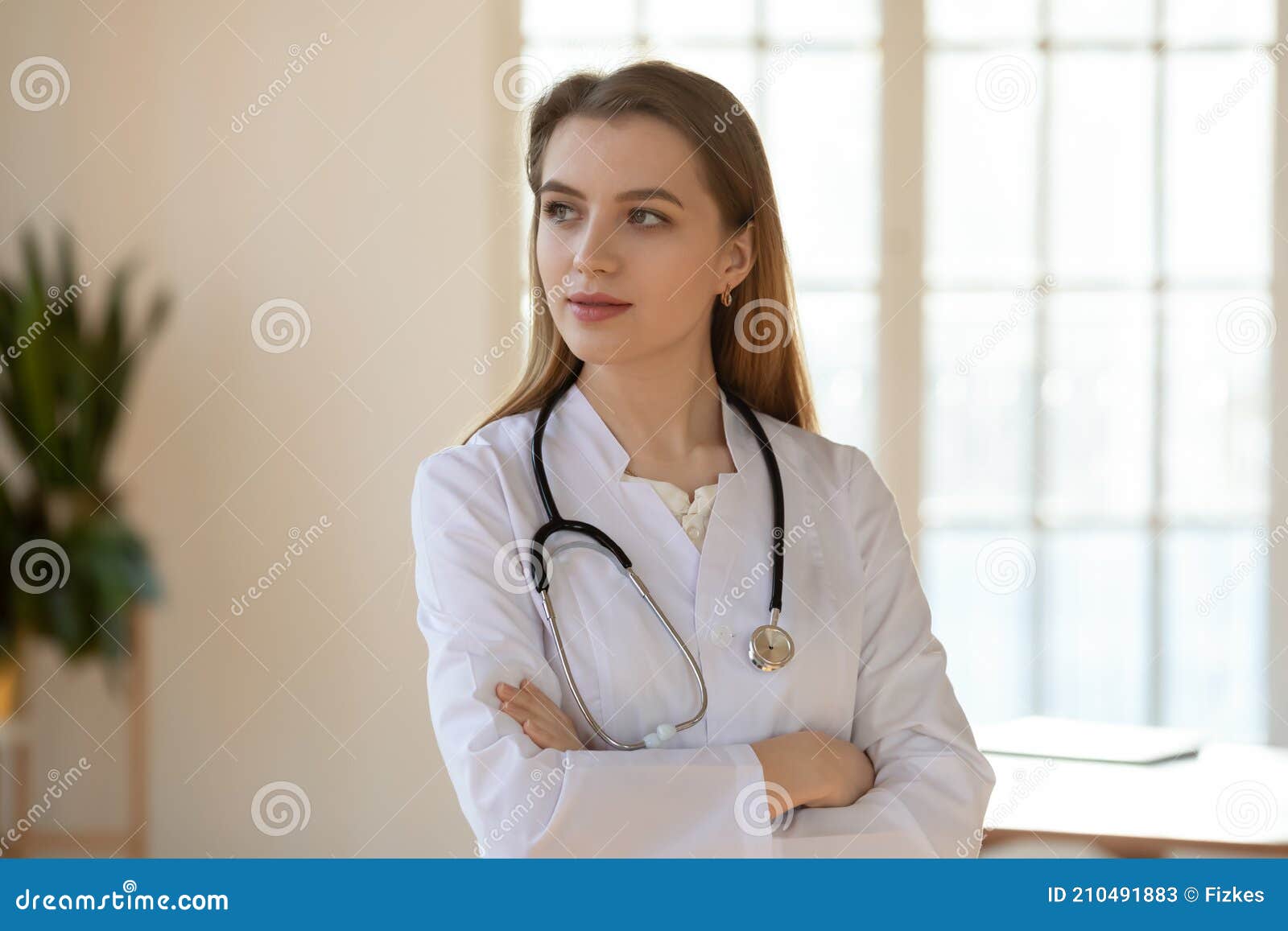 thoughtful confident doctor standing in office looking aside planning decision