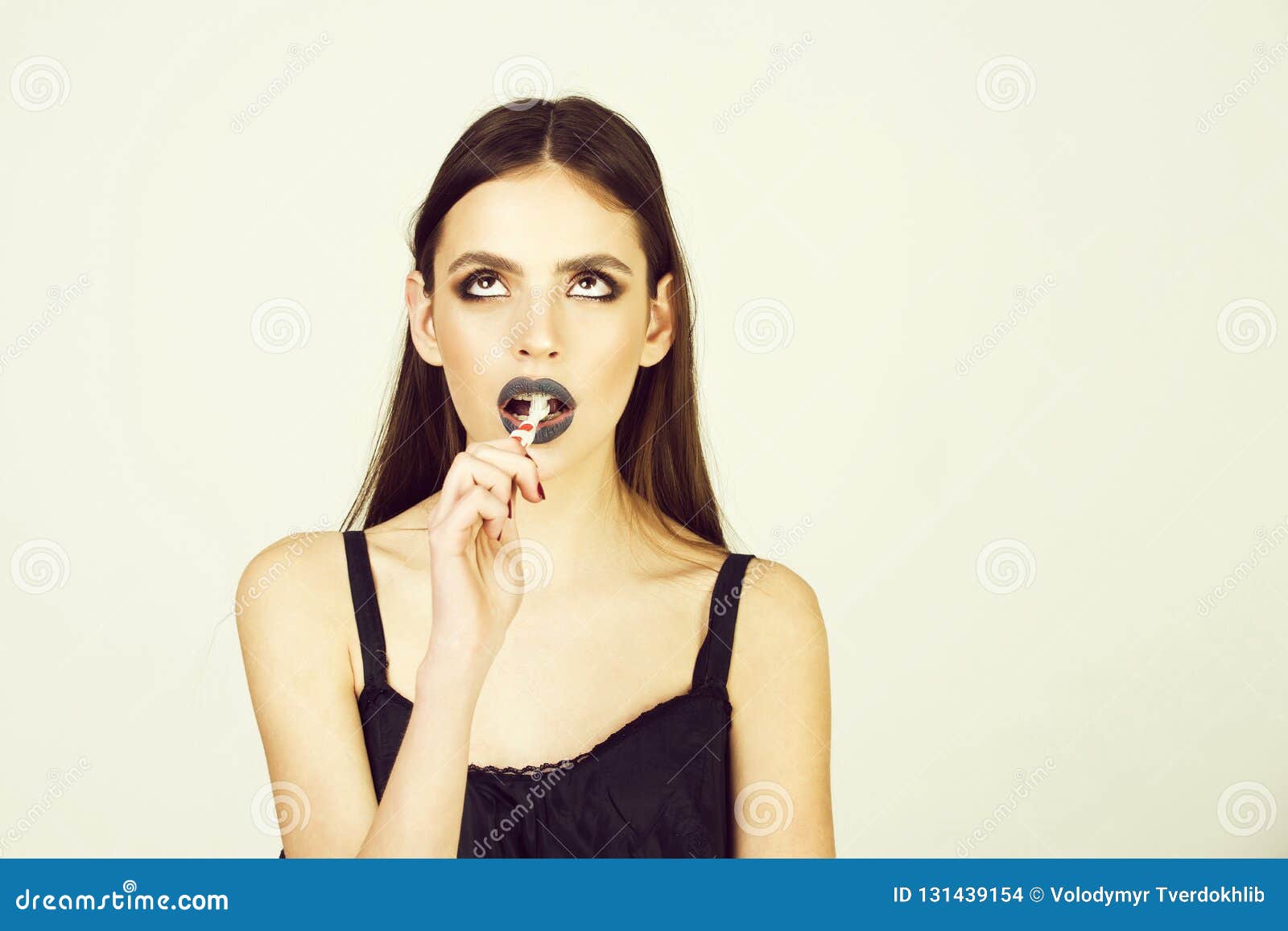Girl With Teeth Braces And Brush Has Fashionable Makeup Stock Photo