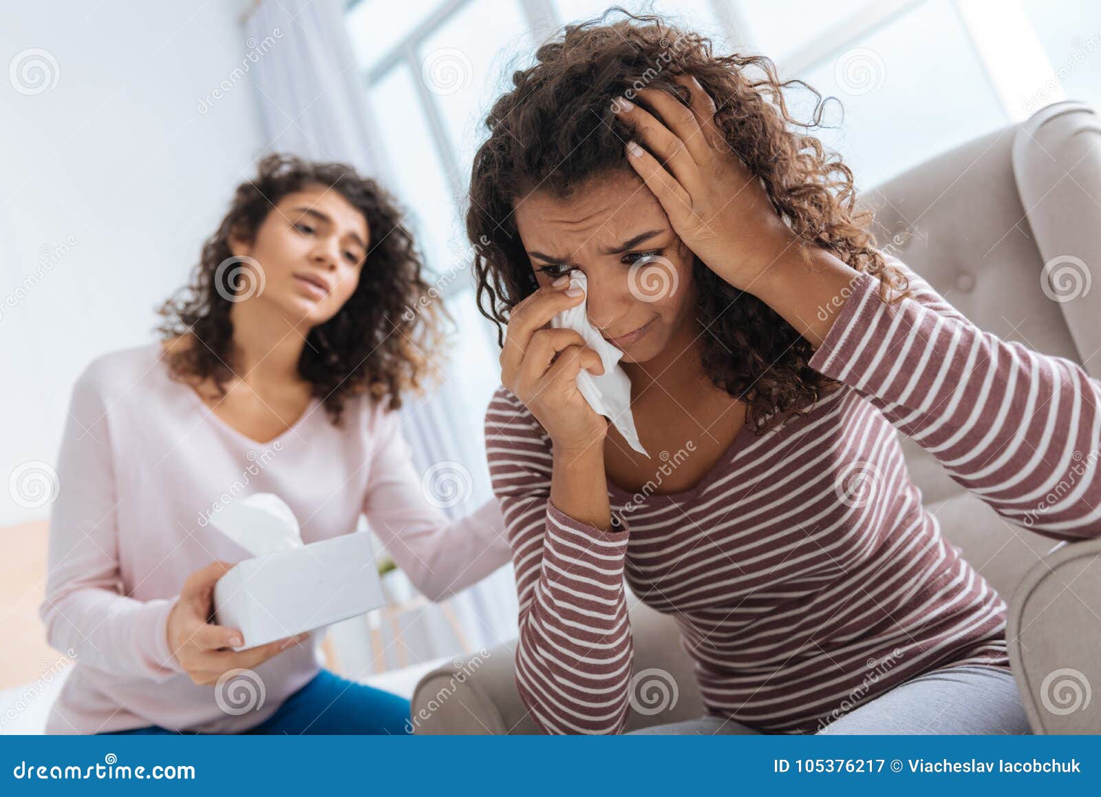 Thoughtful Girl Calming Her Depressed Sister Crying Stock