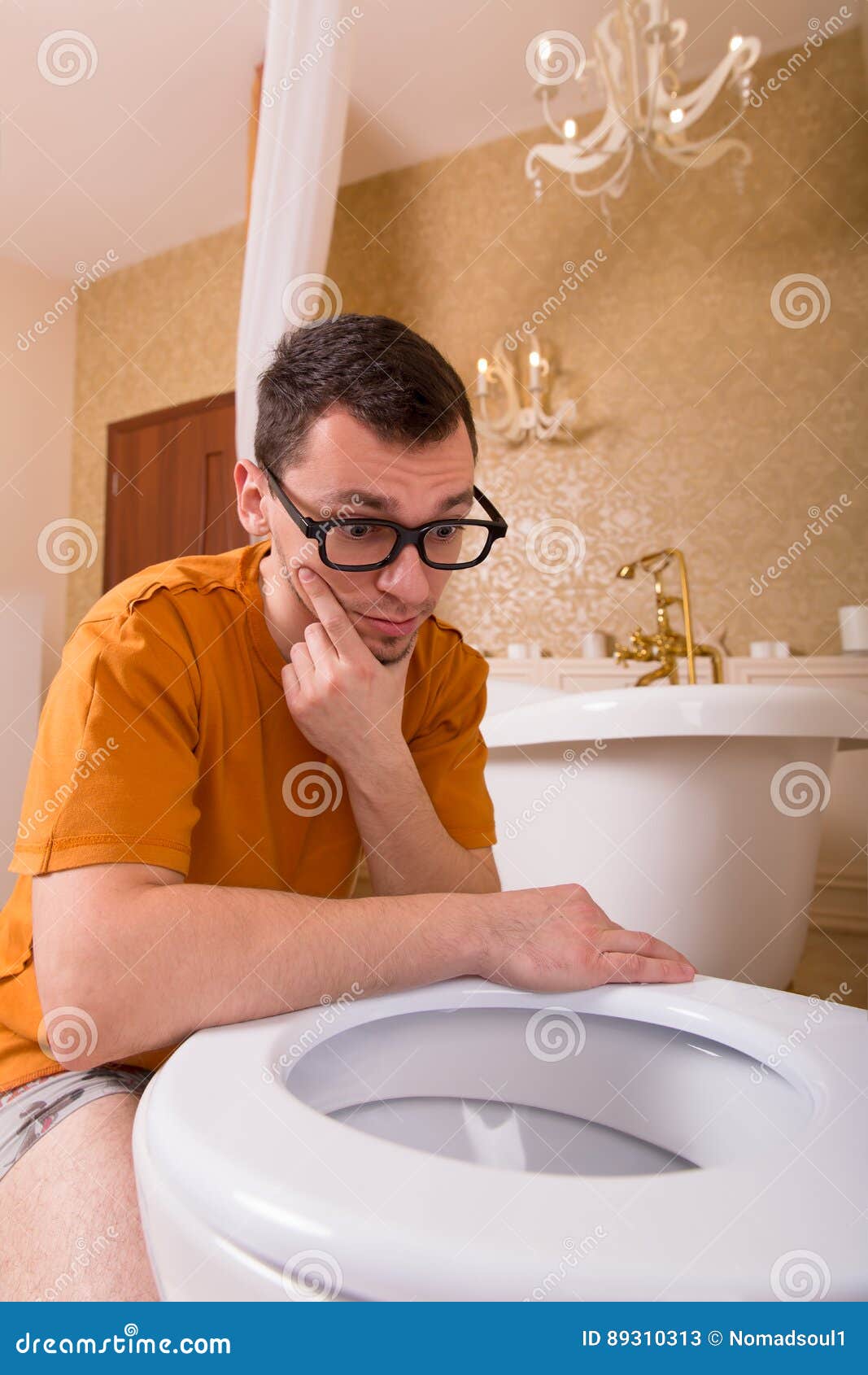 Thoughtful Boy Sitting On The Toilet. Stock Photo - Image 