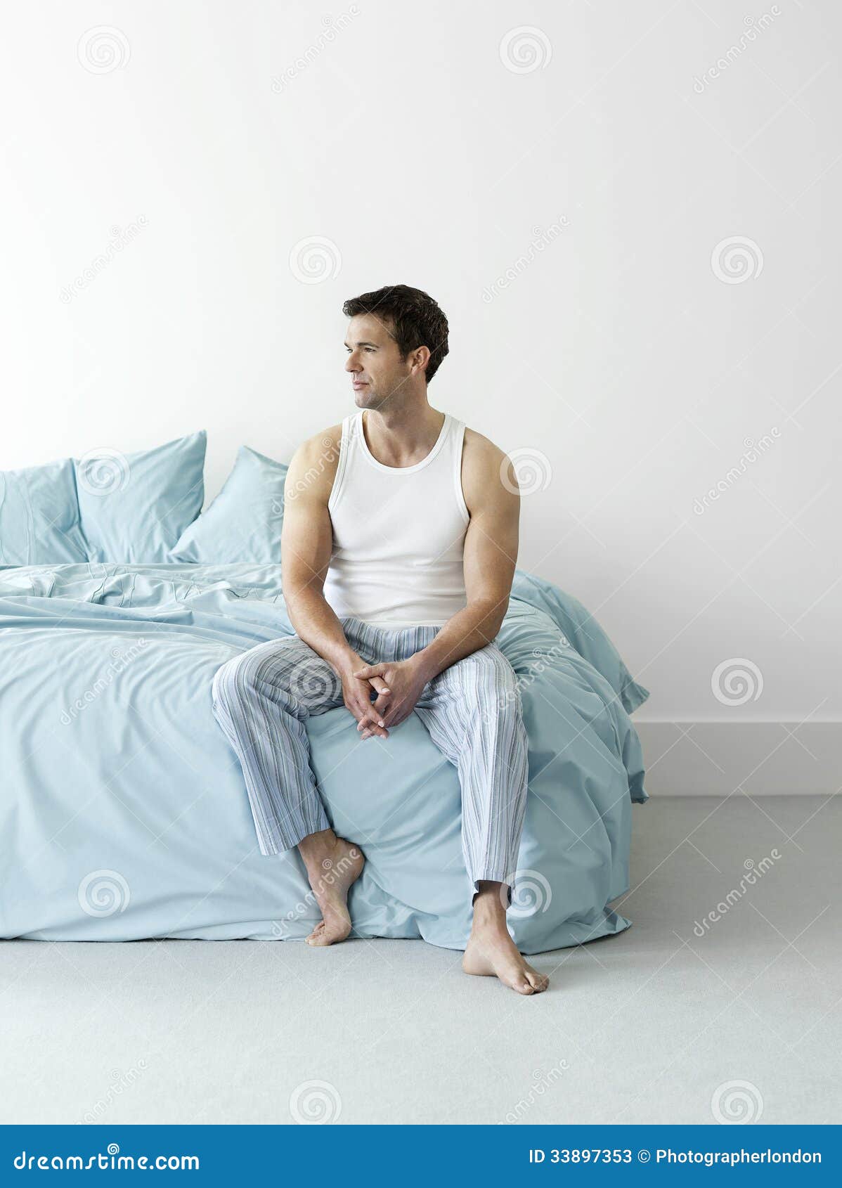 Thoughtful Man in Nightwear Sitting in Bed Stock Image - Image of adult