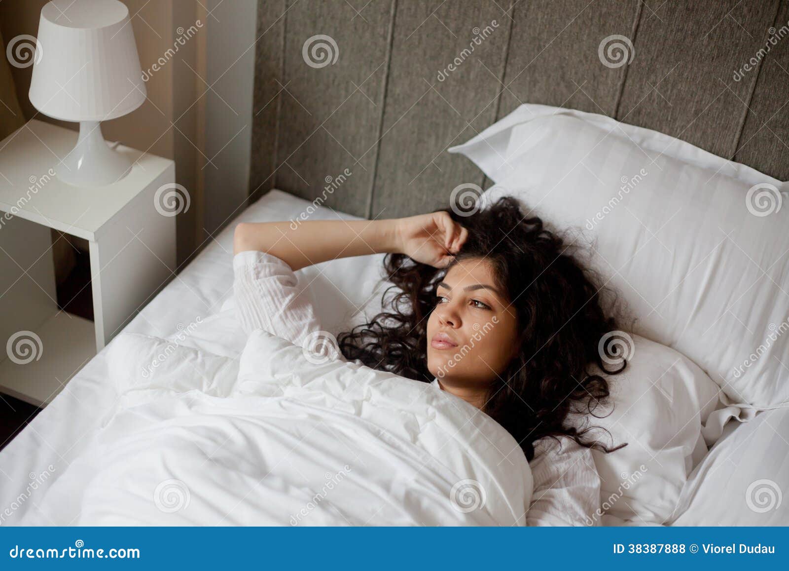 thoughtful woman in bed