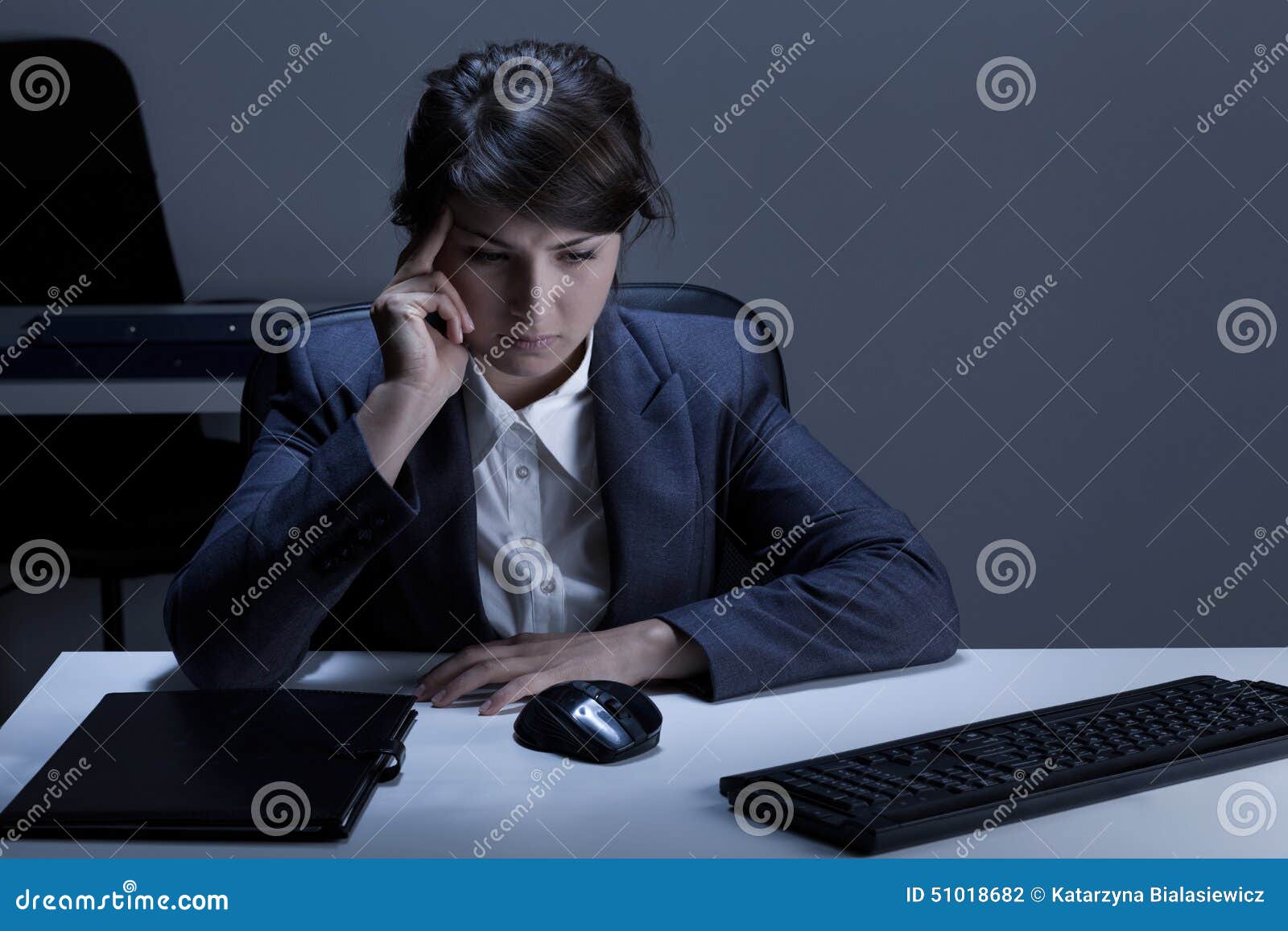 thoughtful woman working overtime