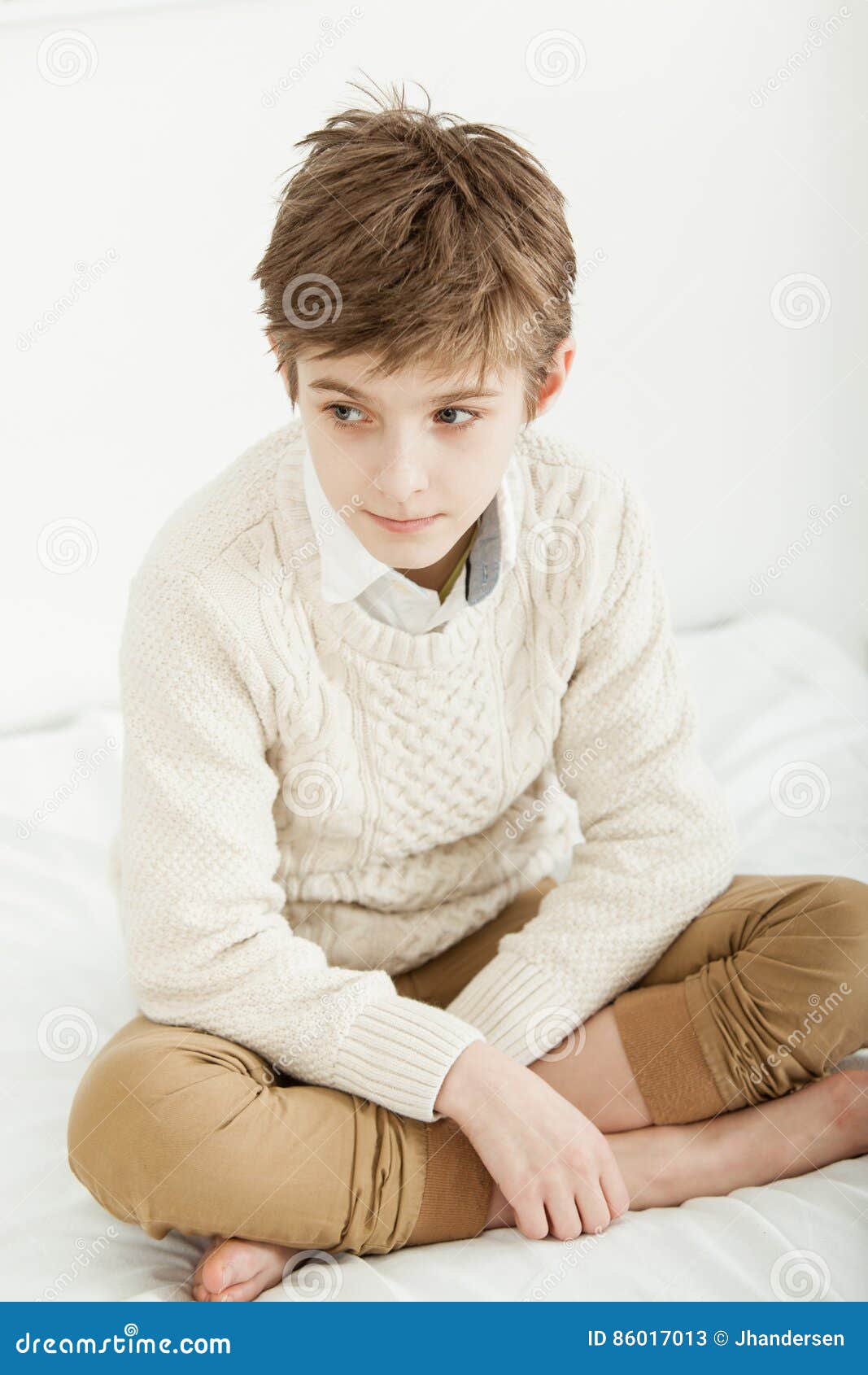 Thoughtful Young Boy Sitting on His Bed Stock Image - Image of ...