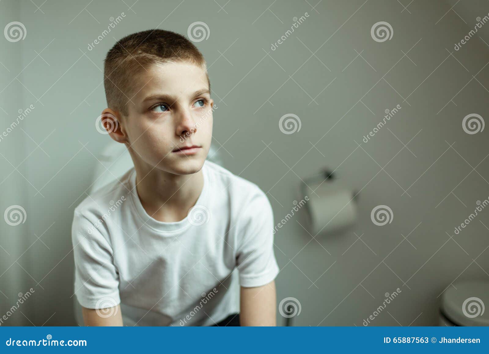 Thoughtful Young Boy Sitting on Toilet Seriously Stock Image ...