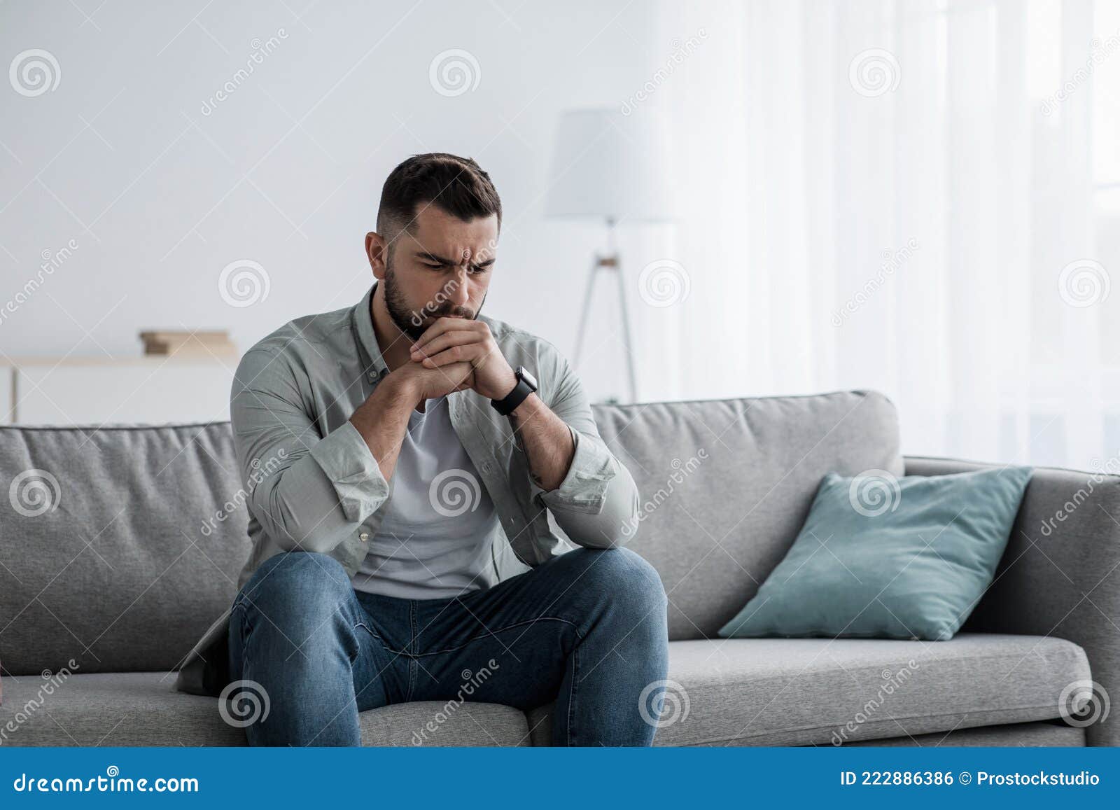 Thoughtful Young Serious Handsome Man Sit on Sofa at Home, Lost in ...