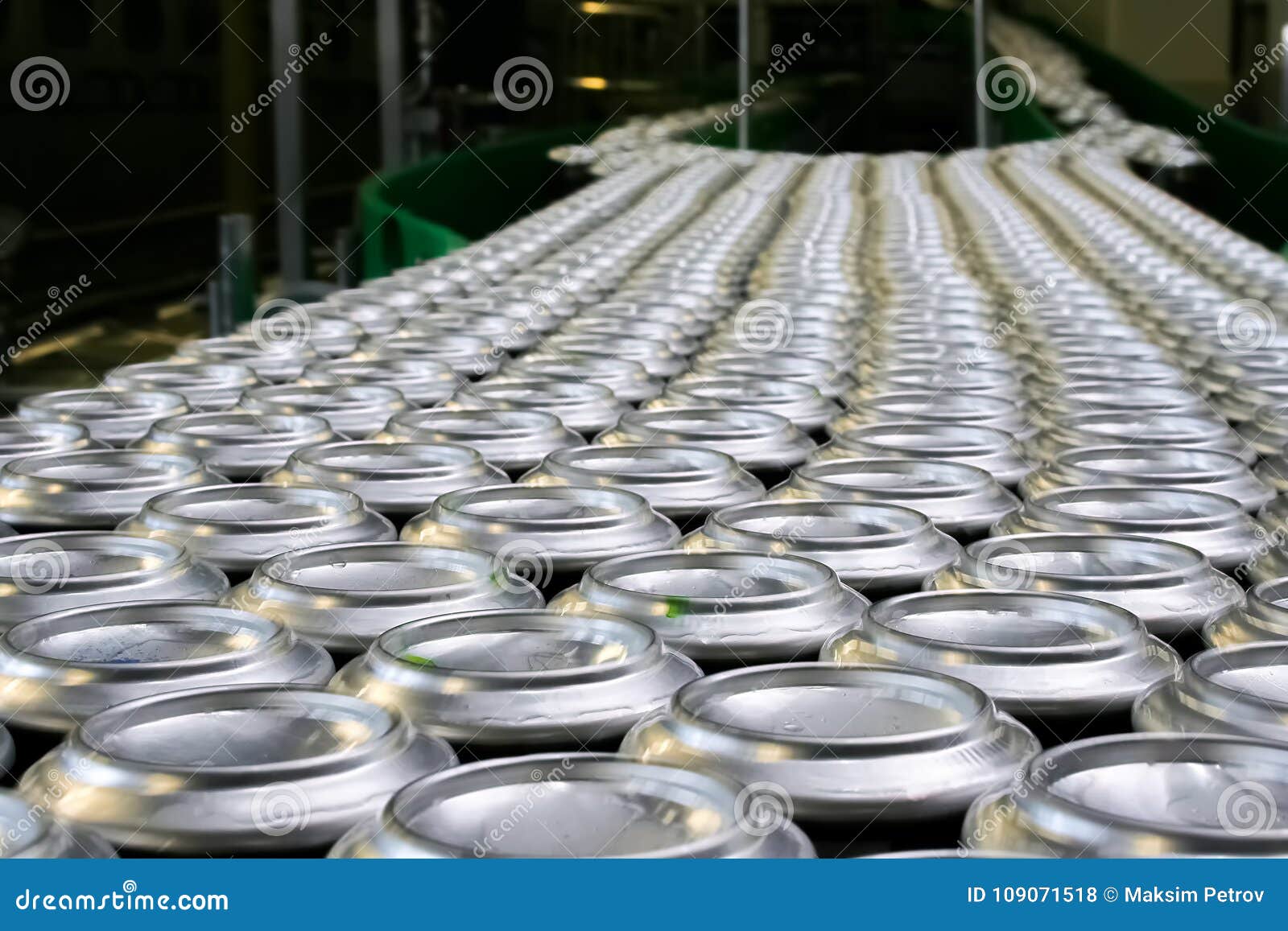 thousands of beverage aluminum cans on conveyor line at factory