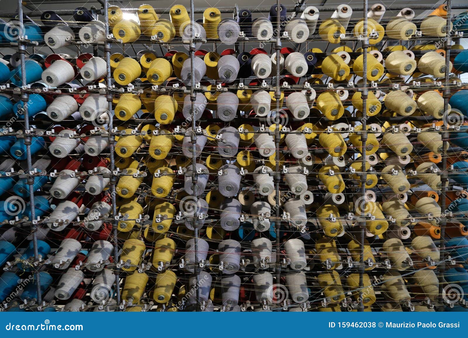 Thread Spools of an Industrial Weaving Loom for Fabrication Stock Photo