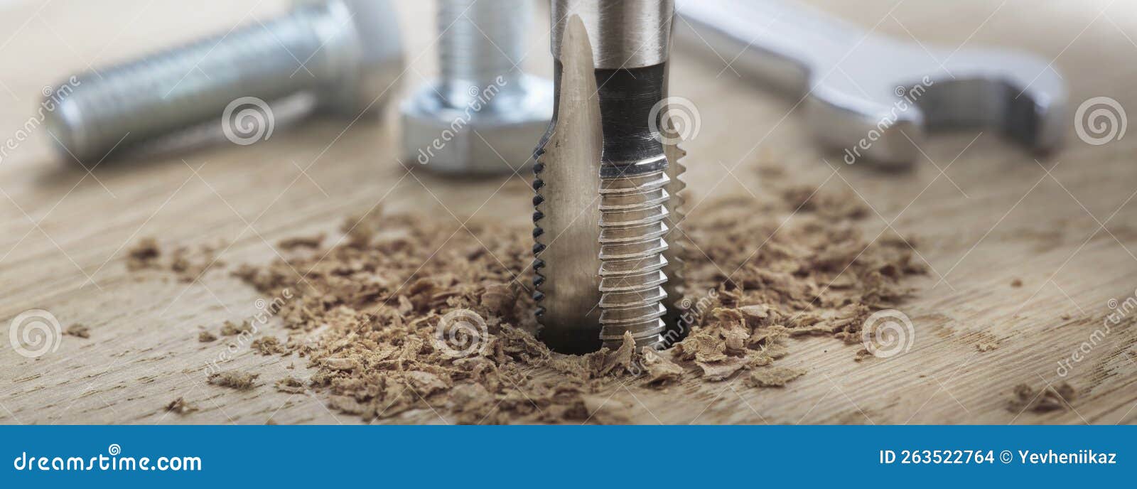 Thread Tap Drill Cutting Hole in Wooden Plate. Working Cutter Stock