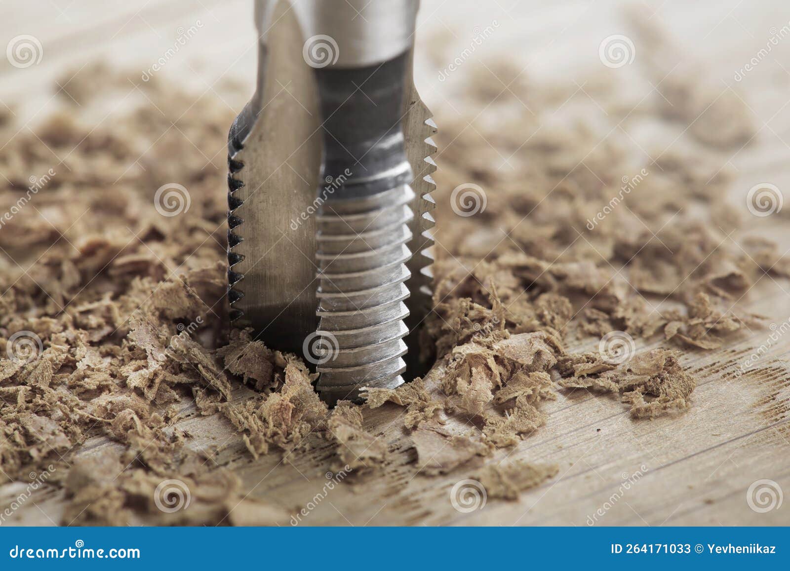 Thread Tap Drill Cutting Hole in Wooden Plate. Working Cutter Stock