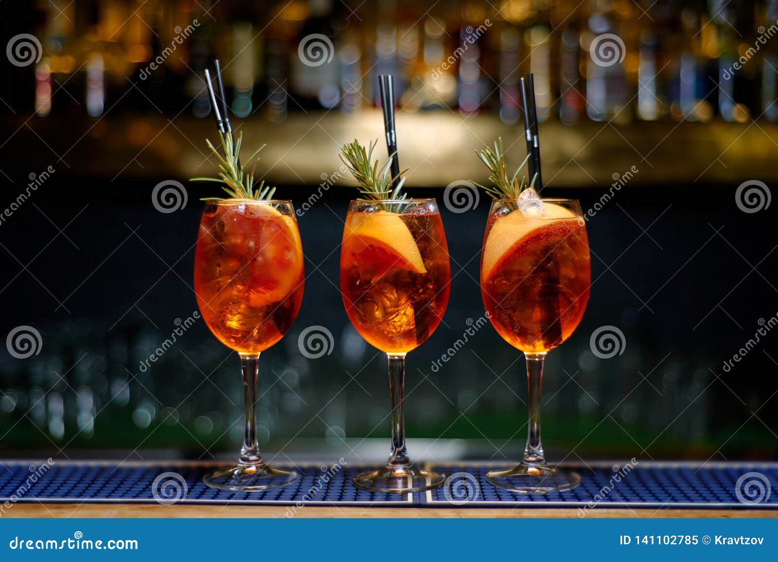 Three Aperol Spritz Cocktail Decorated with Rosemary at Bar Counter