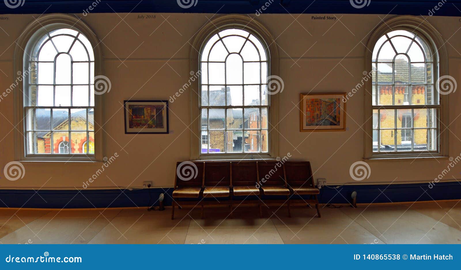 Three Arched Windows and Bench from Inside Looking Out. Editorial Stock