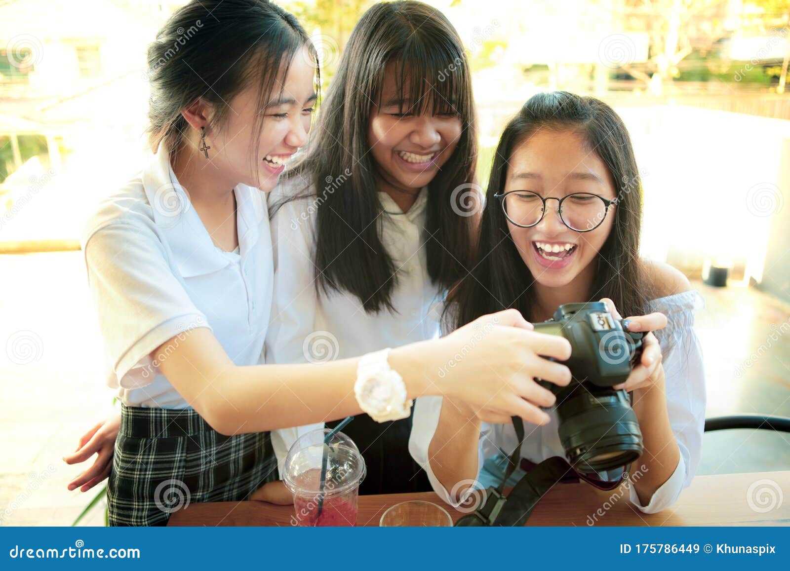 Three asian teenager with dslr camera in hand pose as fashion model. |  CanStock