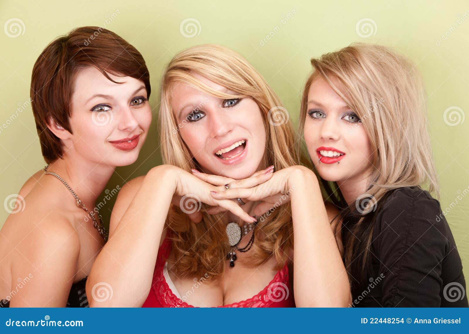 Three Attractive Teen Girls Smile For A Portrait Stock