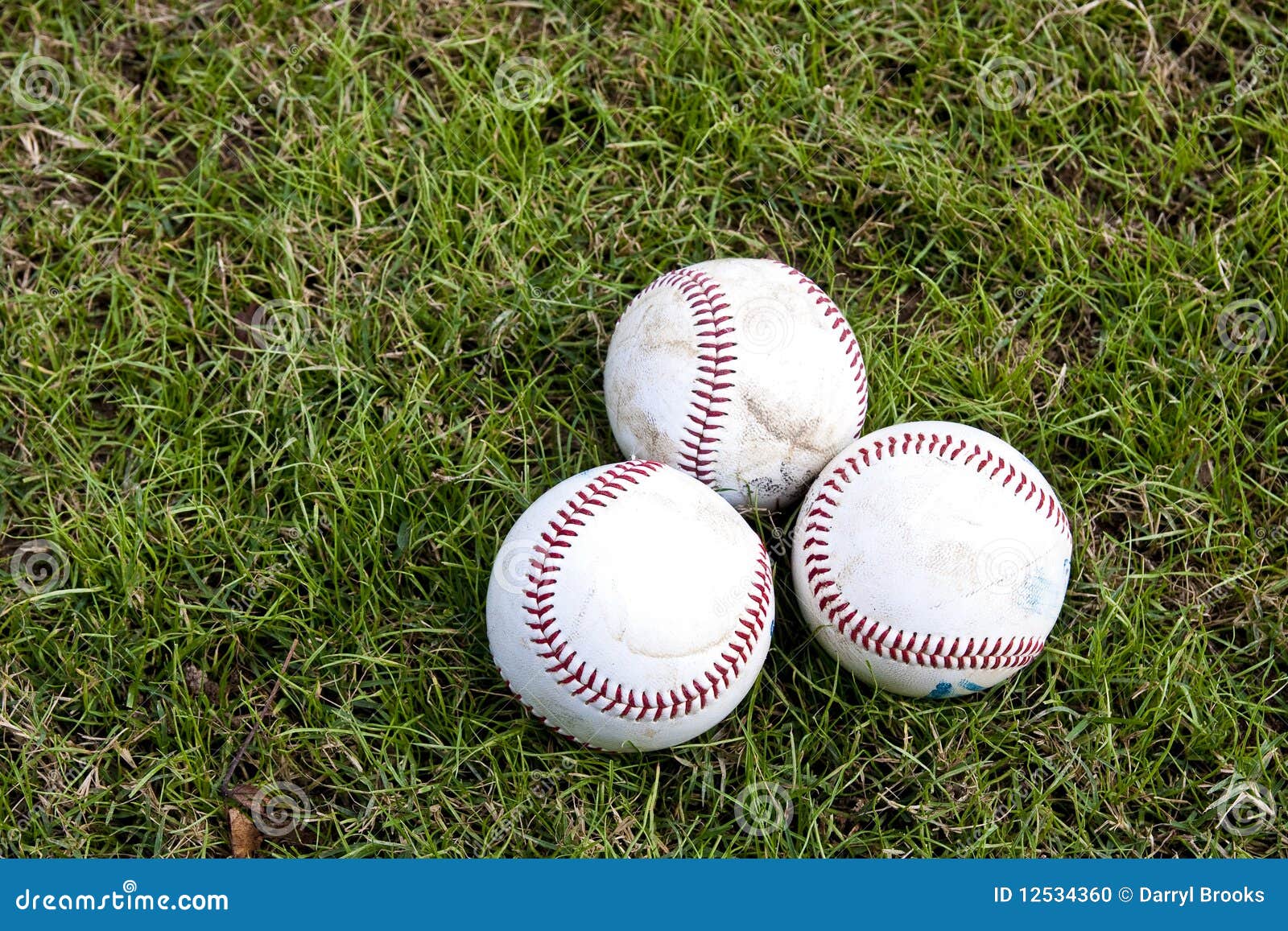 Three Baseballs in Grass stock photo. Image of sport 12534360