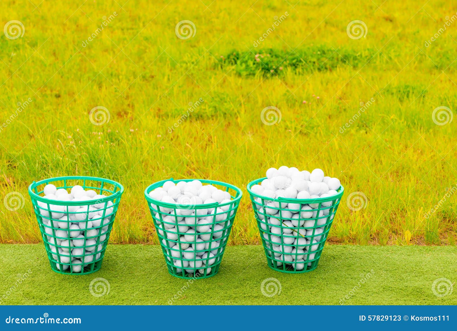 Three Baskets Filled with Golf Balls on the Grass Stock Image - Image