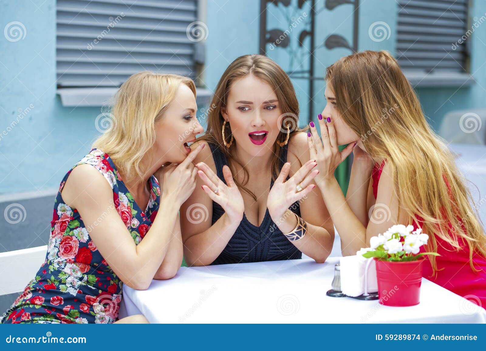 three beautiful girlfriends gossiping woman sitting at a table i