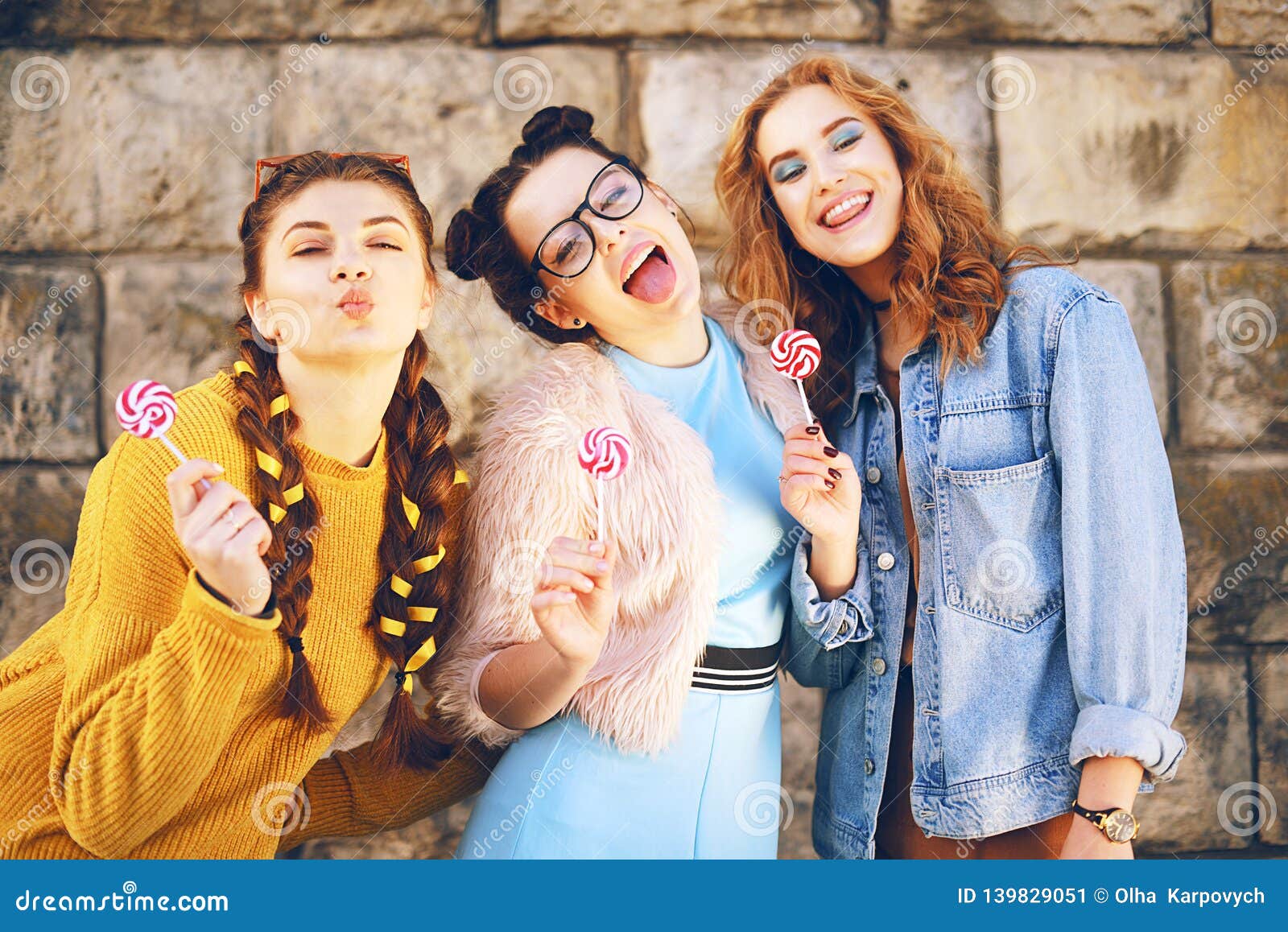 Three Beautiful Girls Eat Lollipops And Drink Lemonad In