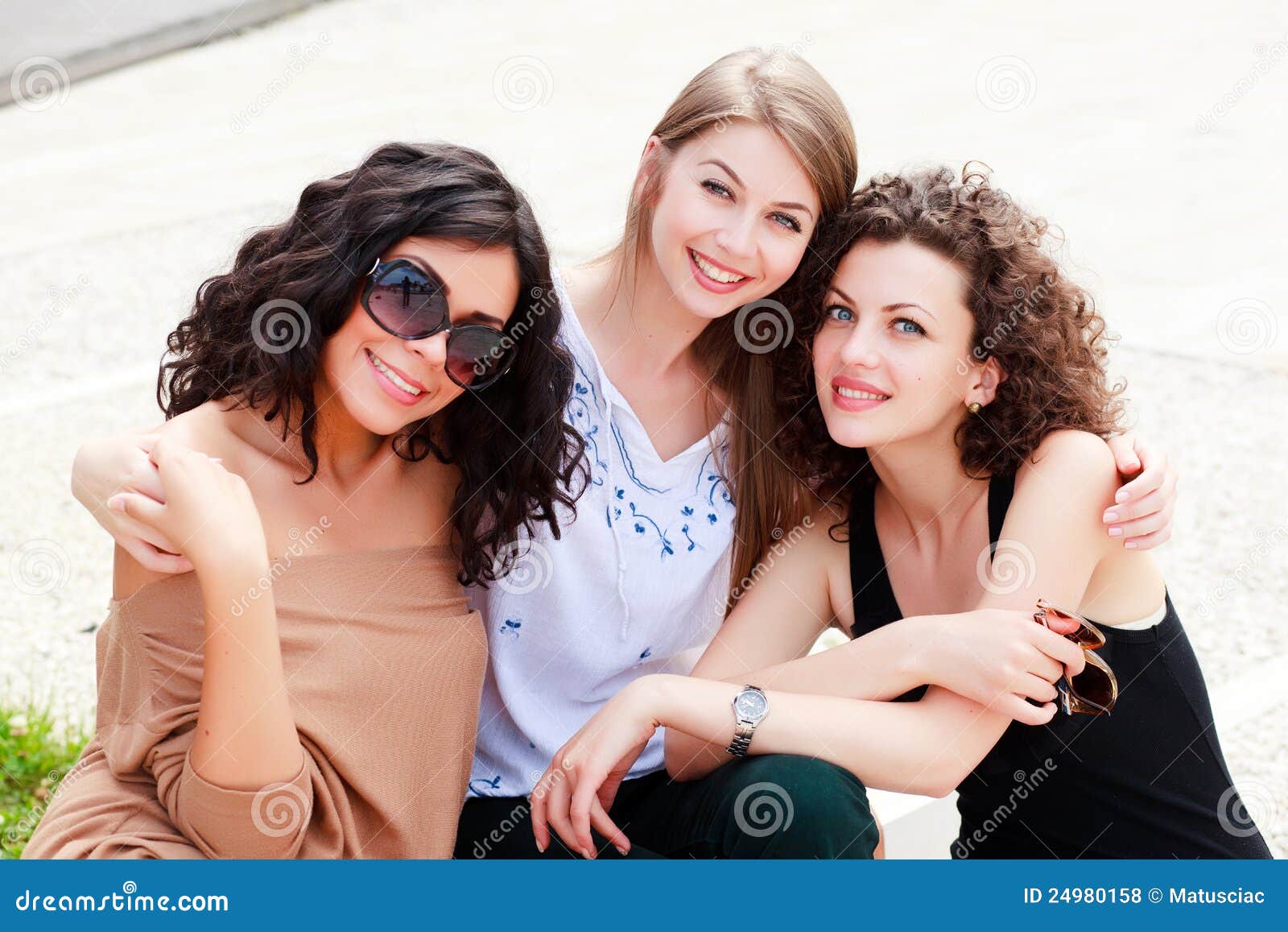 Three beautiful women smiling. Three beautiful women laughing and having fun outdoor