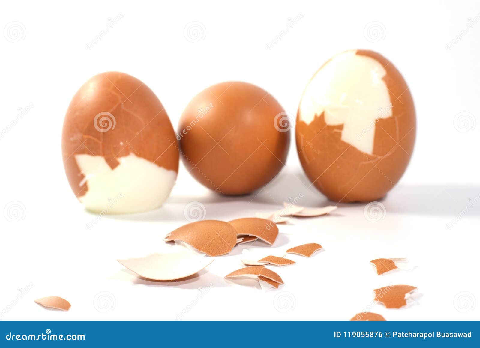 Three Big Brown Eggs is Cracking on White Background Having Pieces of