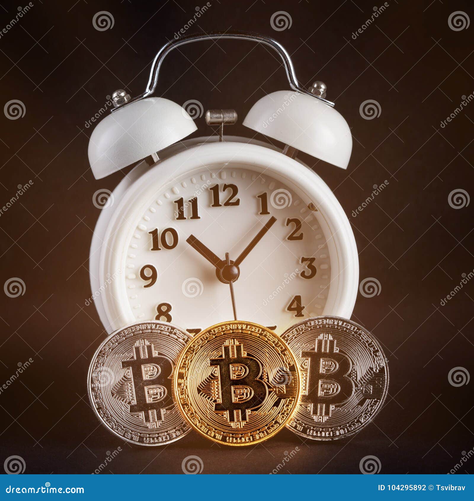 Three Bitcoins And Vintage White Alarm Clock Glowing On Black