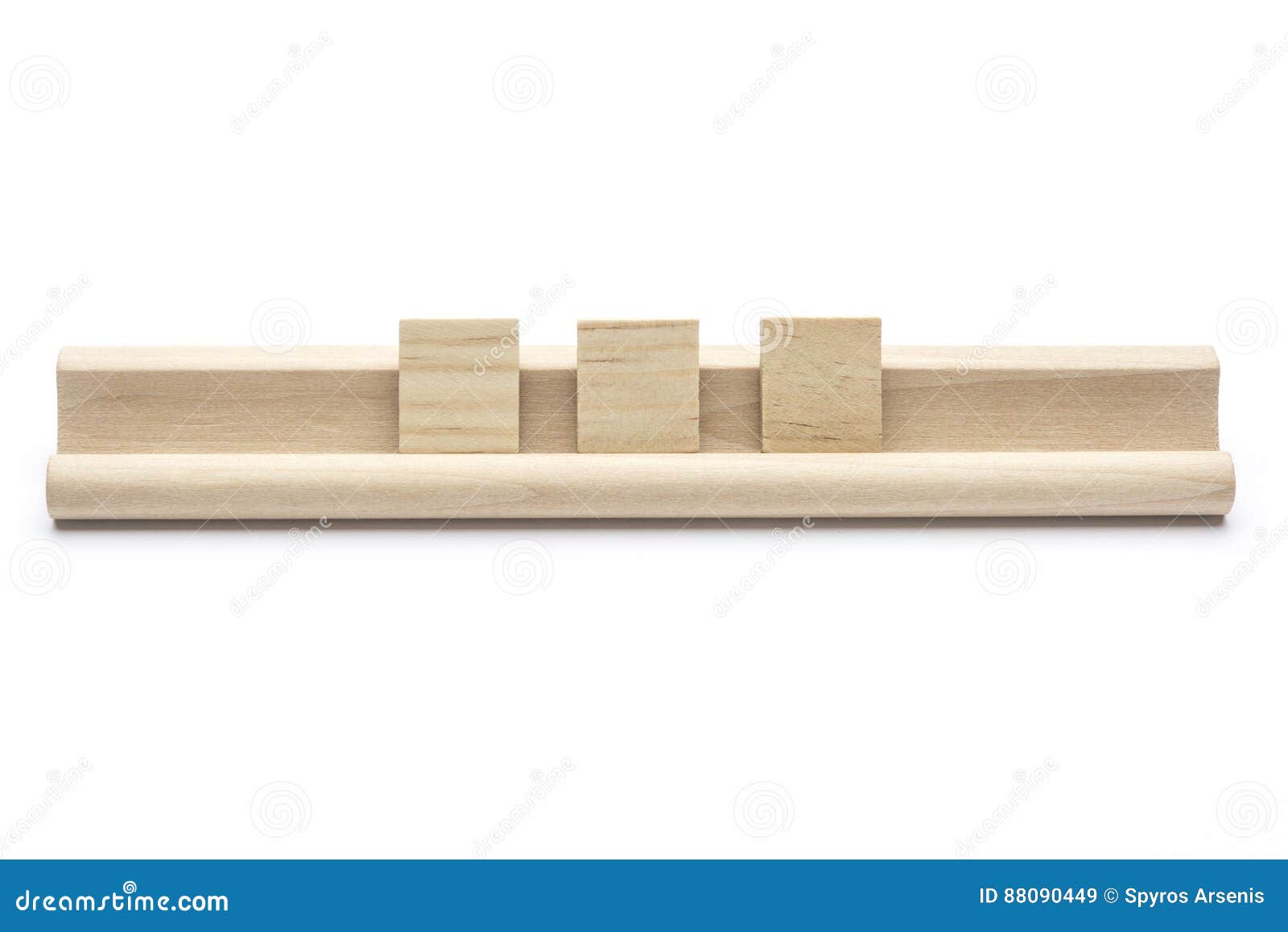 three blank scrabble tiles on a wooden rack