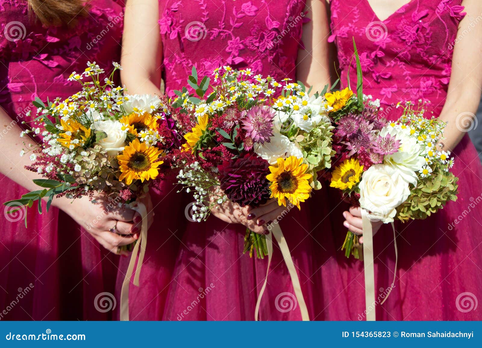 Three Bridesmaids in Lilac Lace Dresses with Bouquets of Fresh Flowers ...