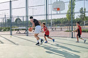 Three Brothers Playing Basketball One Of Them Has A Leg Prosthesis Three Brothers Playing Basketball One Of Them Has A Leg Prosthesis