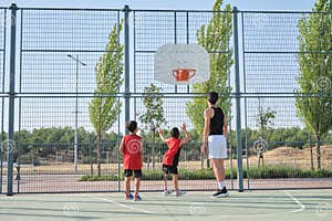 Three Brothers Playing Basketball One Of Them Has A Leg Prosthesis Three Brothers Playing Basketball One Of Them Has A Leg Prosthesis