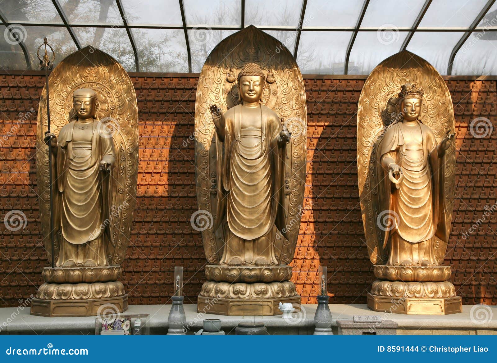 three buddhas on dais