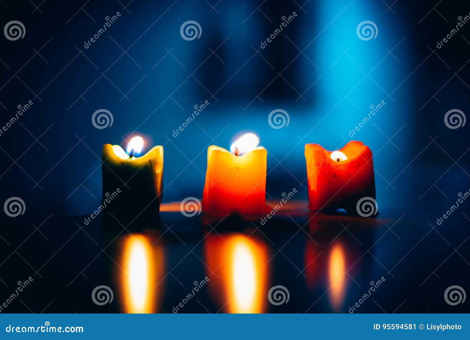 Three Burning Candles in a Row with Blue Background Stock Image Image
