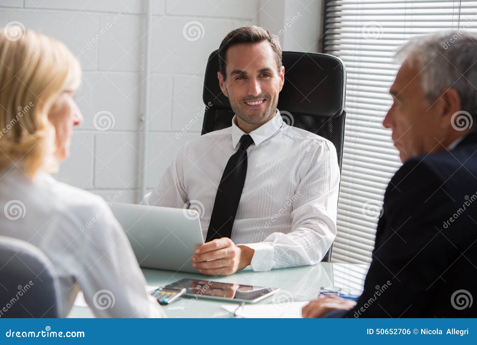 three businesspeople having a meeting in the office