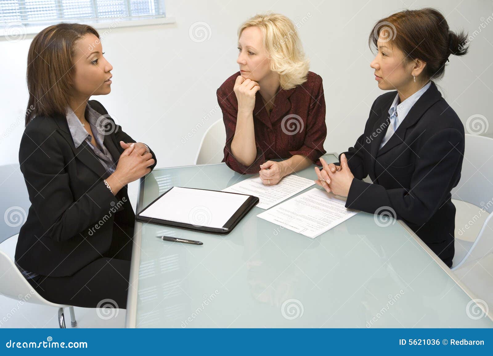 three businesswomen at desk