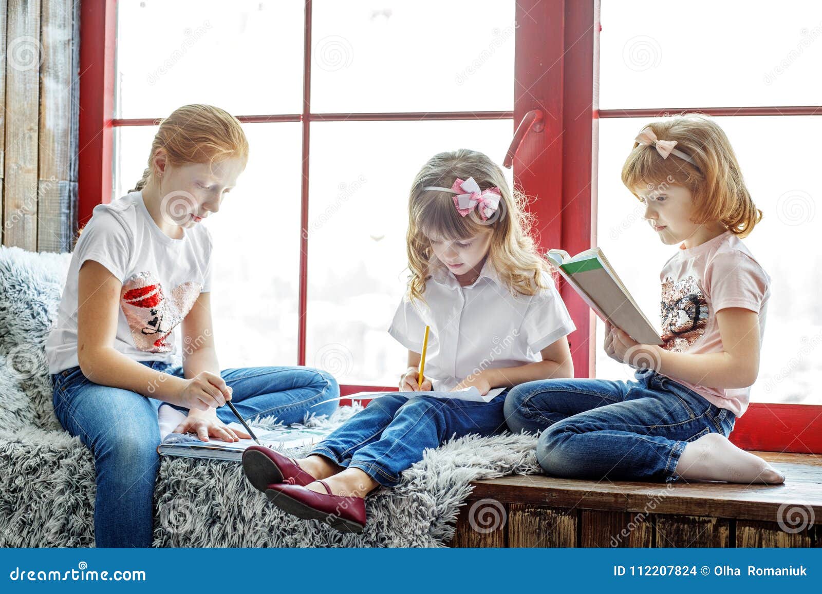 Three Children Read, Draw and Write. a Group of Children is Stud Stock