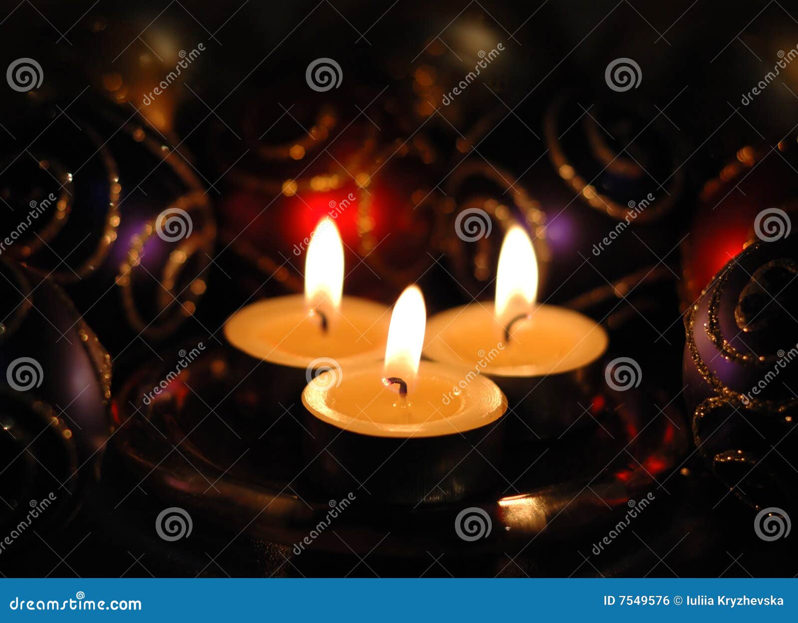 Three Christmas tea lights stock photo. Image of flame 7549576
