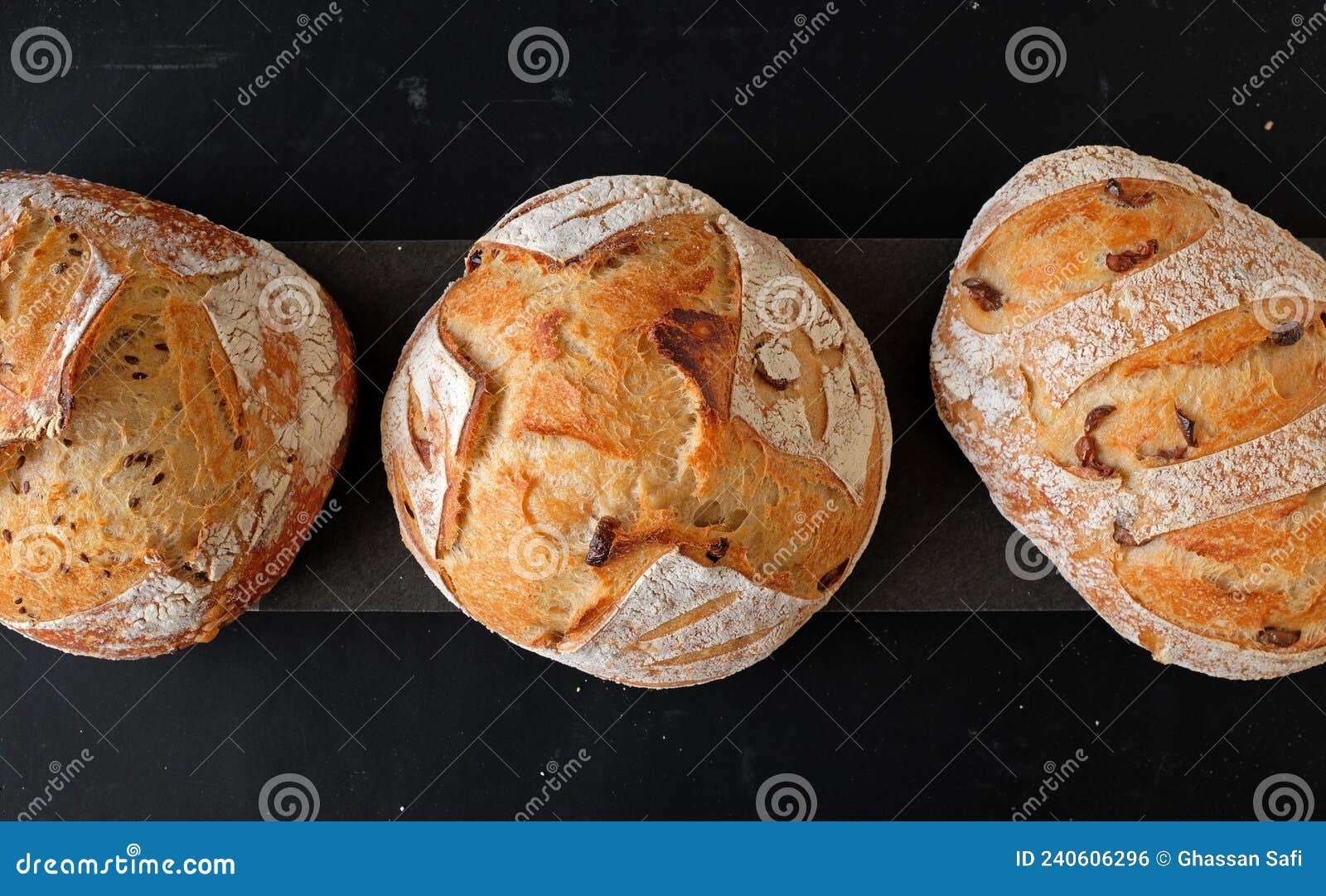 three circular-d sourdoughs on dark background (top view)