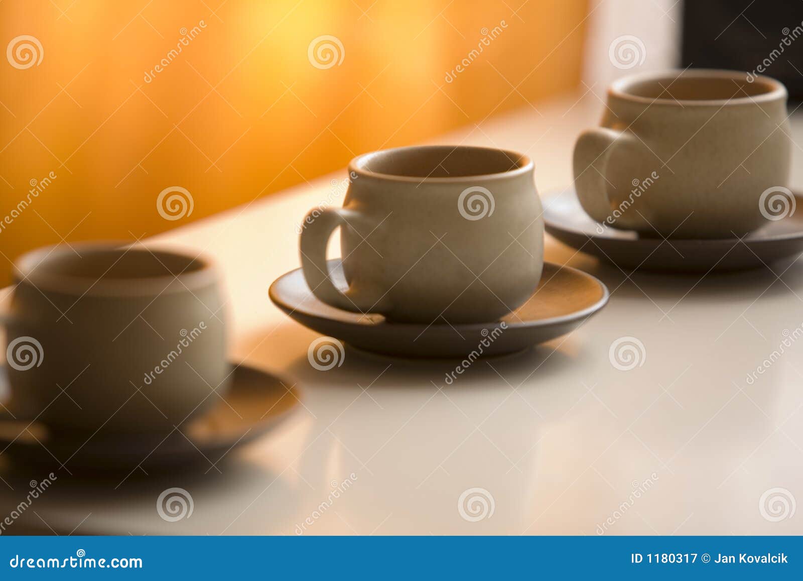 three coffee cups and saucers