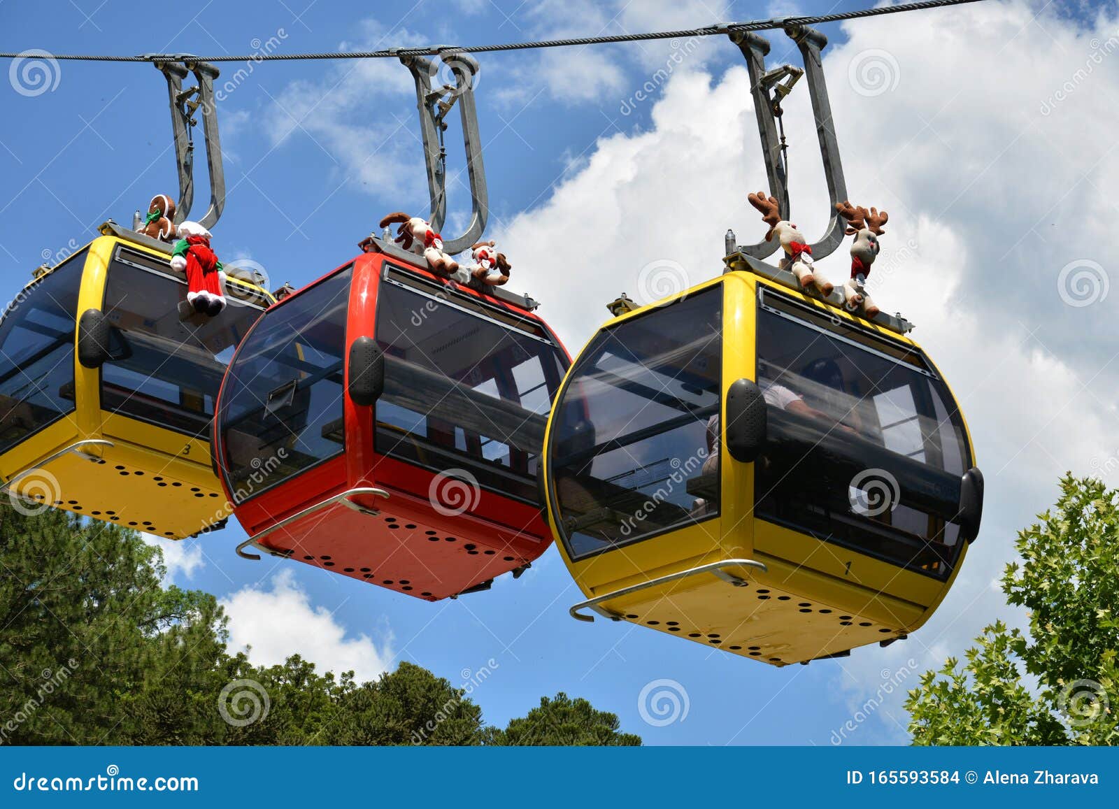 three colorful gondolas cable cars as they transport people up and down in the caracol park, brazil