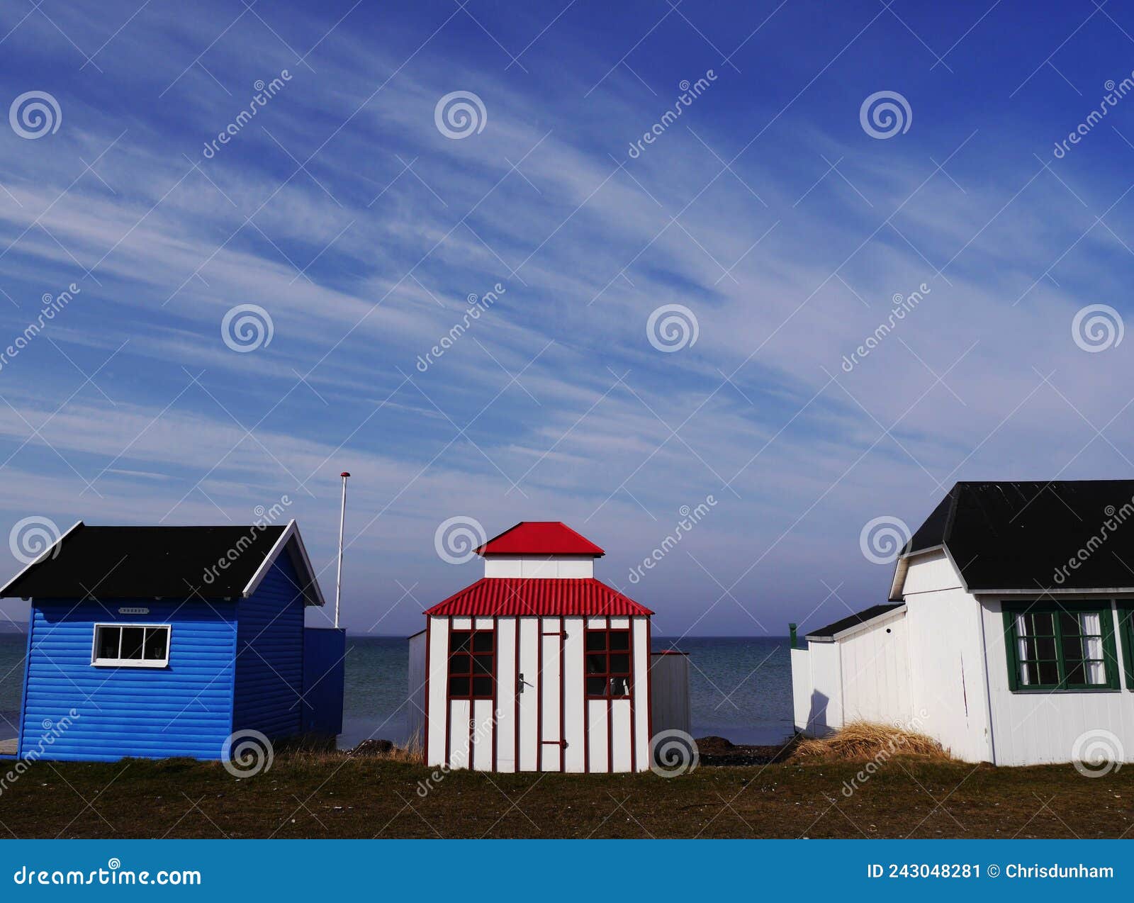 three colourful beach huts in row on danish island of aeroskobing