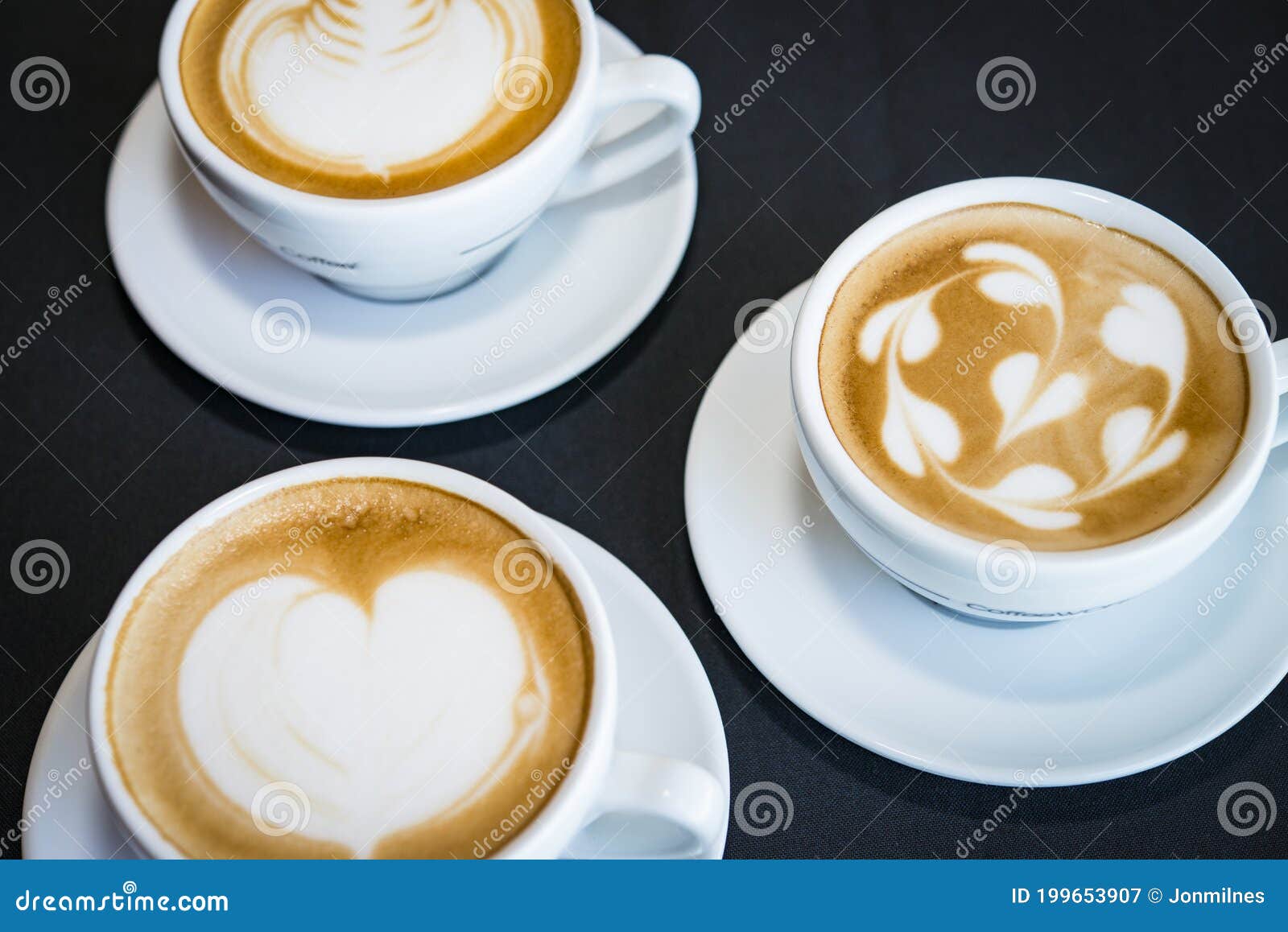 three cups of hot cappuccino coffees