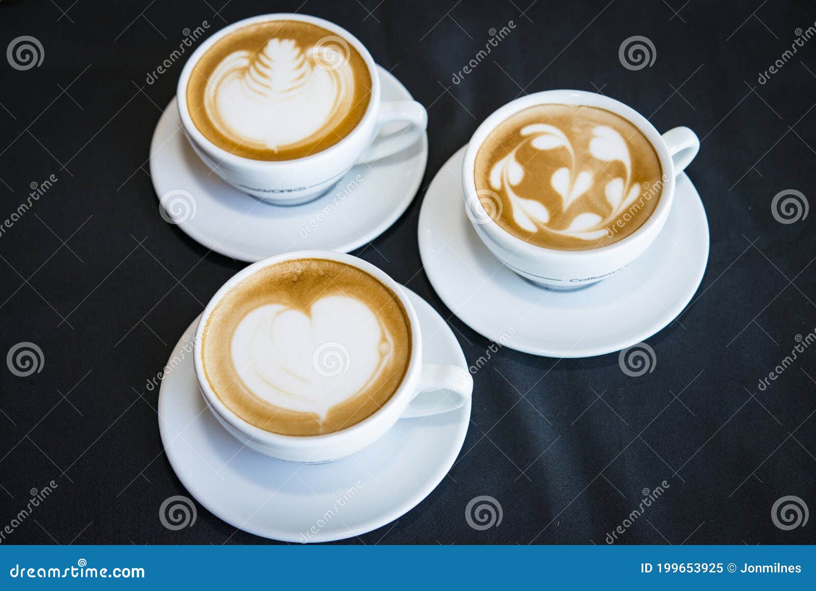 three cups of hot cappucino coffees