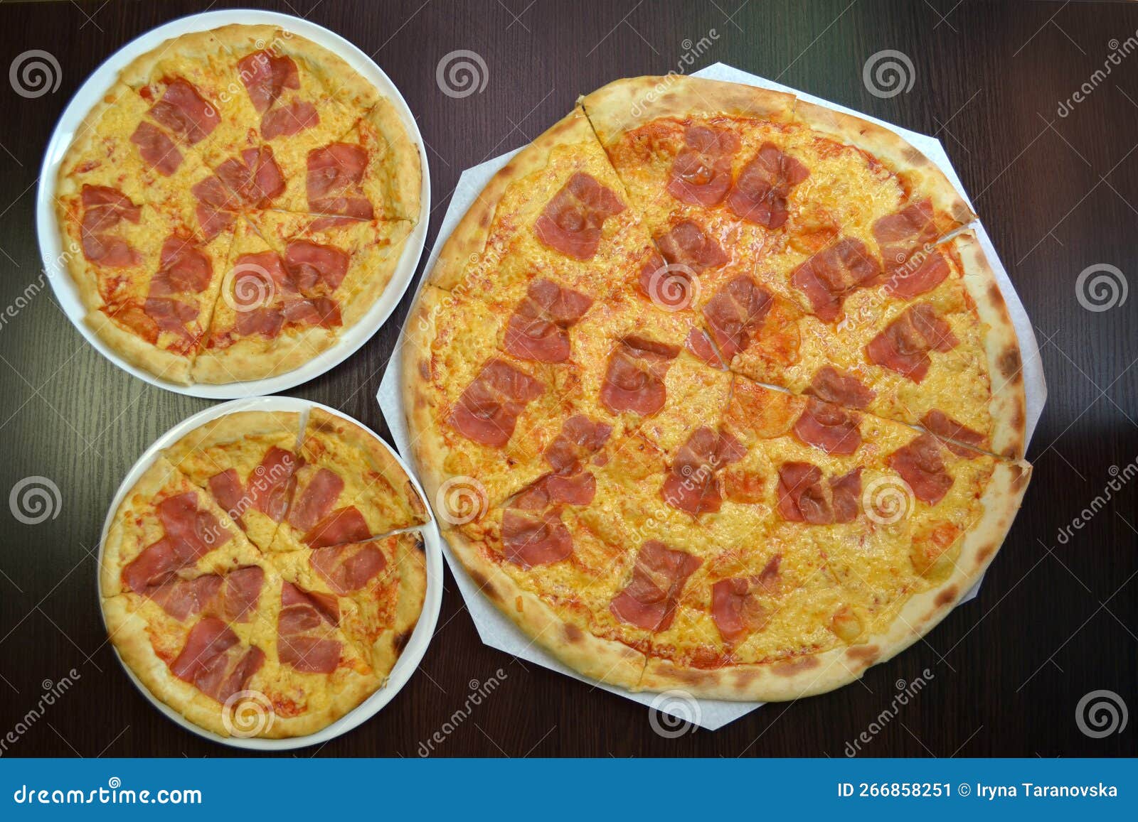 Three Delicious Fresh Cheese Pizzas with Prosciutto on Black Table