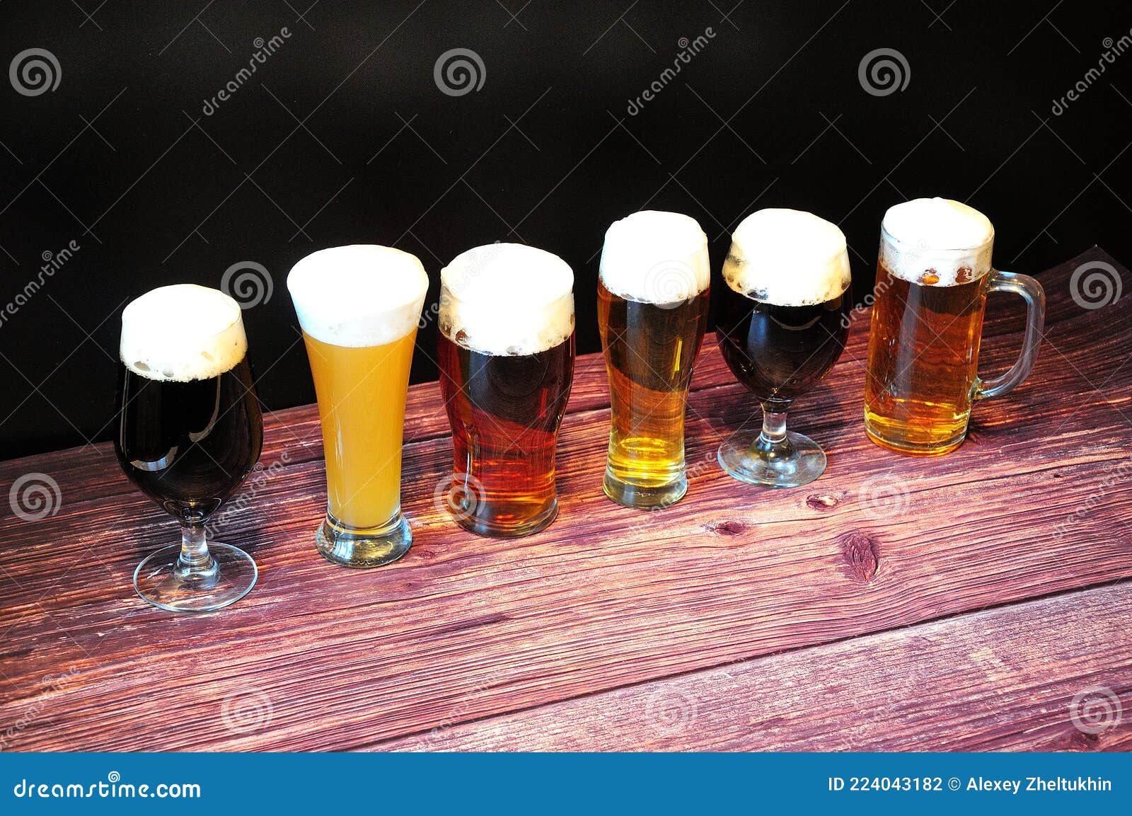 Three Different Beer Glasses, with Different Types of Beer, are in a