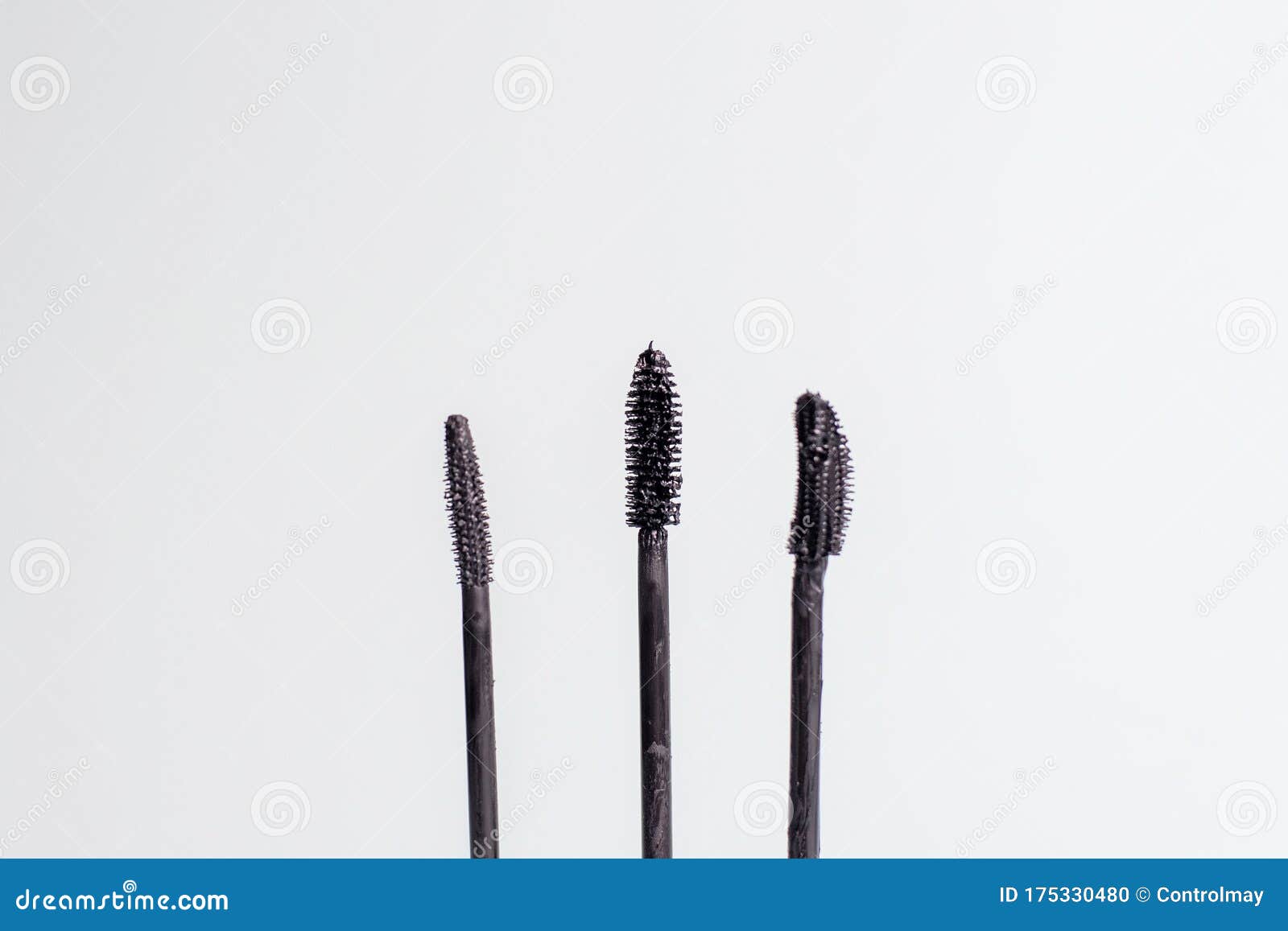 Three Different Mascara Brushes. Various Mascara Brushes on a Blue