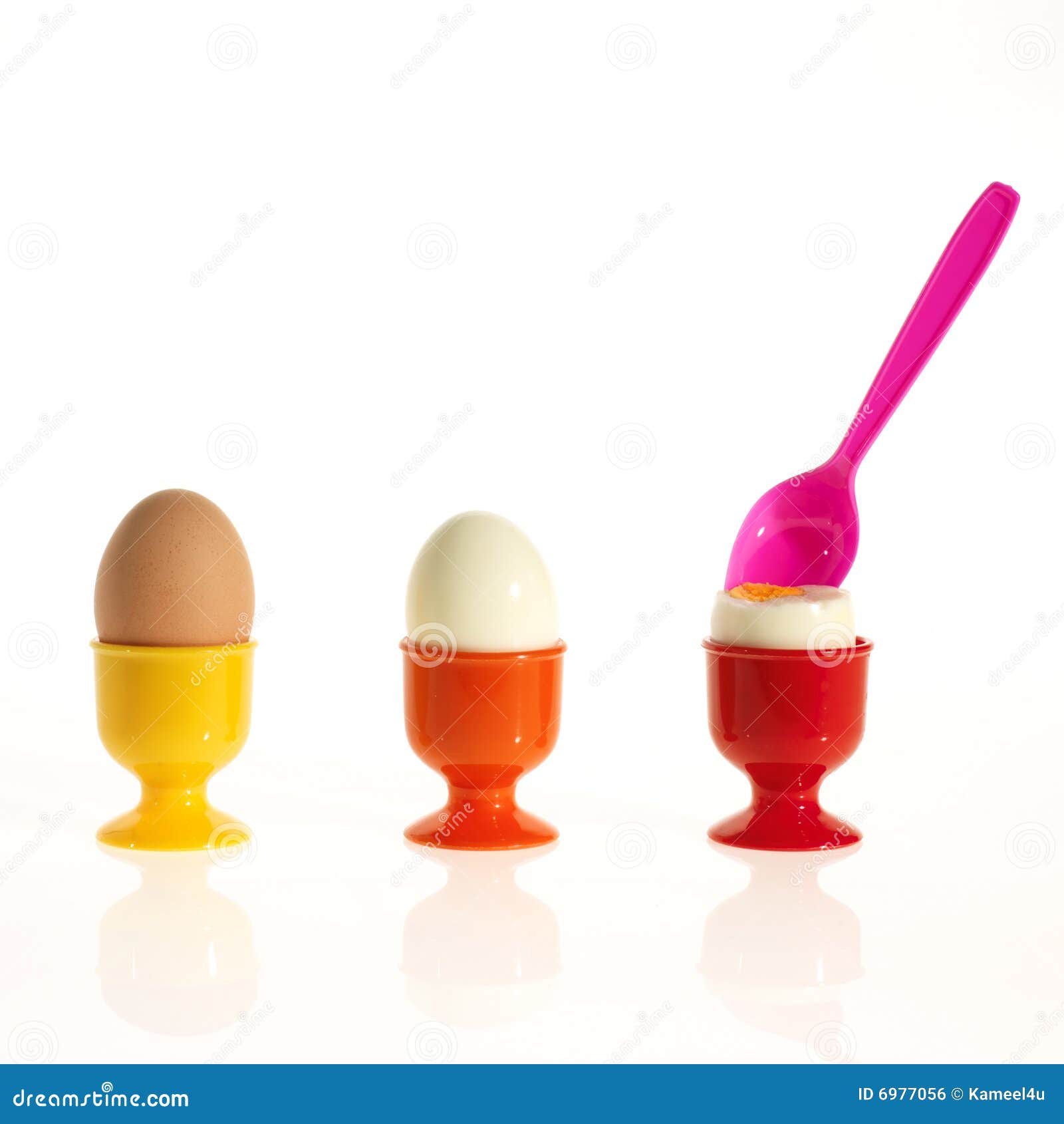 Three Eggs in Colorful Egg Cups with a Spoon Stock Photo Image of
