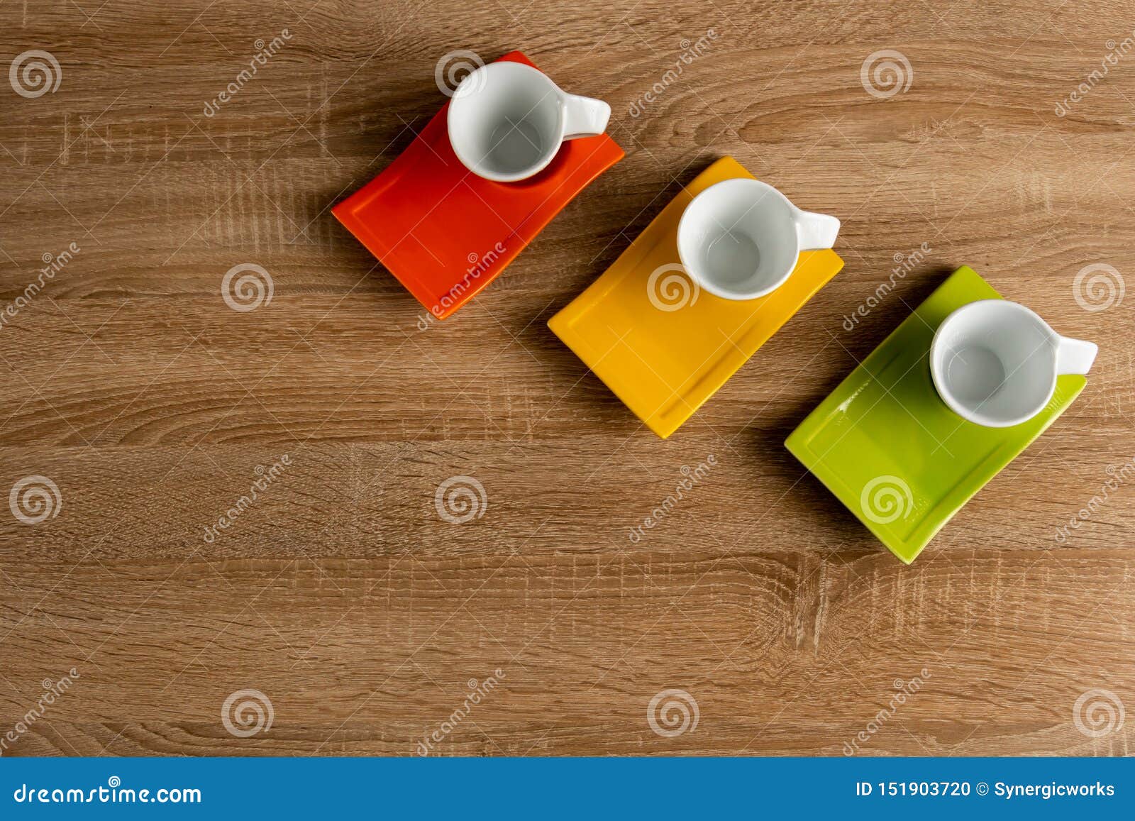 three empty cups of coffee on desk on right corner