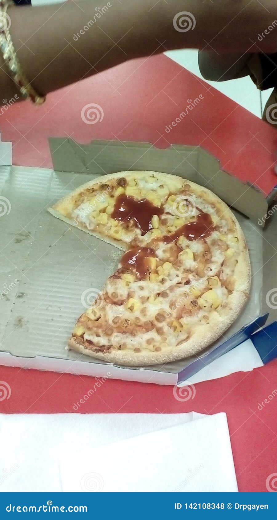 Three Fourth Of Delivered Pizza With Some Red Sause Remaining On The