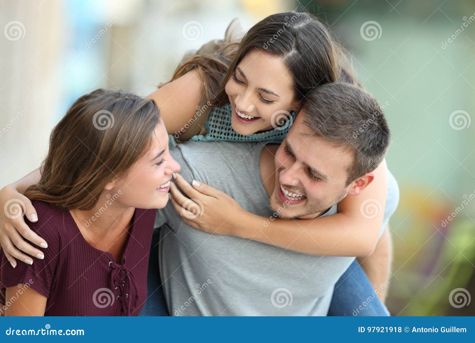 three friends meeting and joking on the street