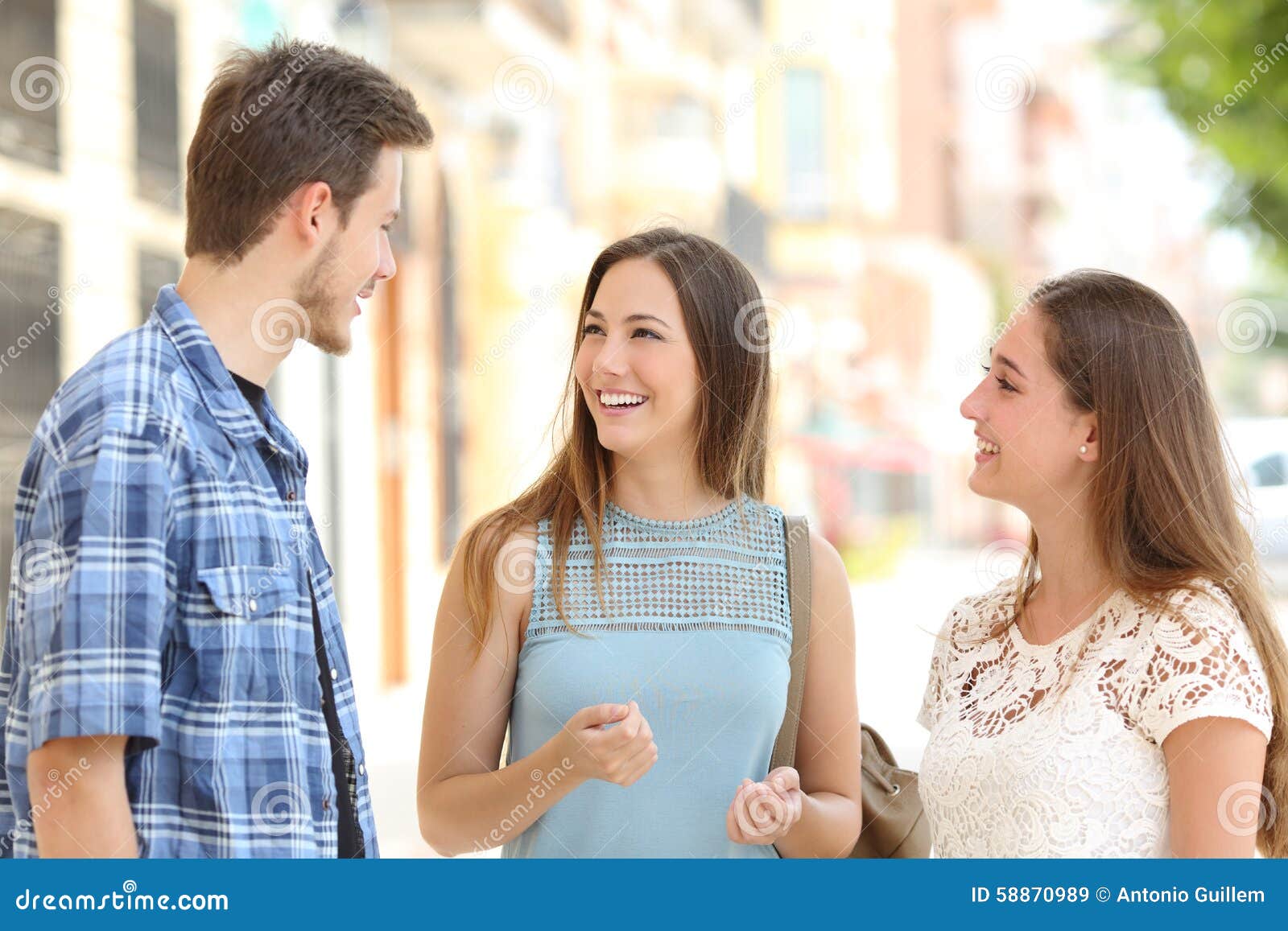 three friends talking taking a conversation on the street